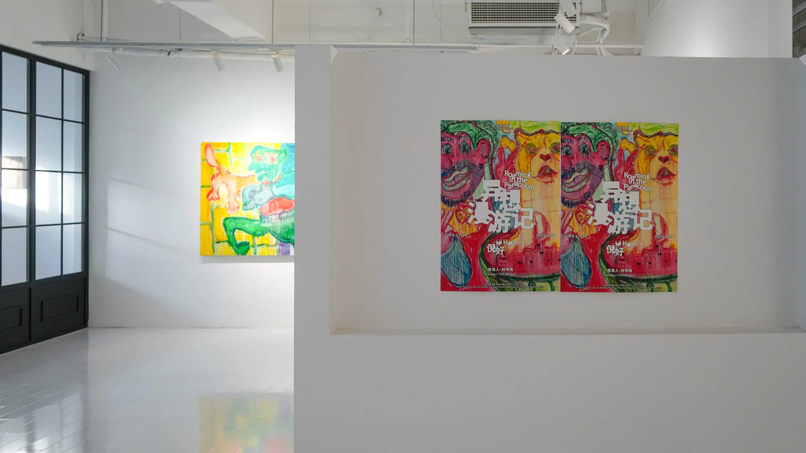 Two gallery walls meeting at a corner, a yellow-green canvas on the left and a red diptych on the right.