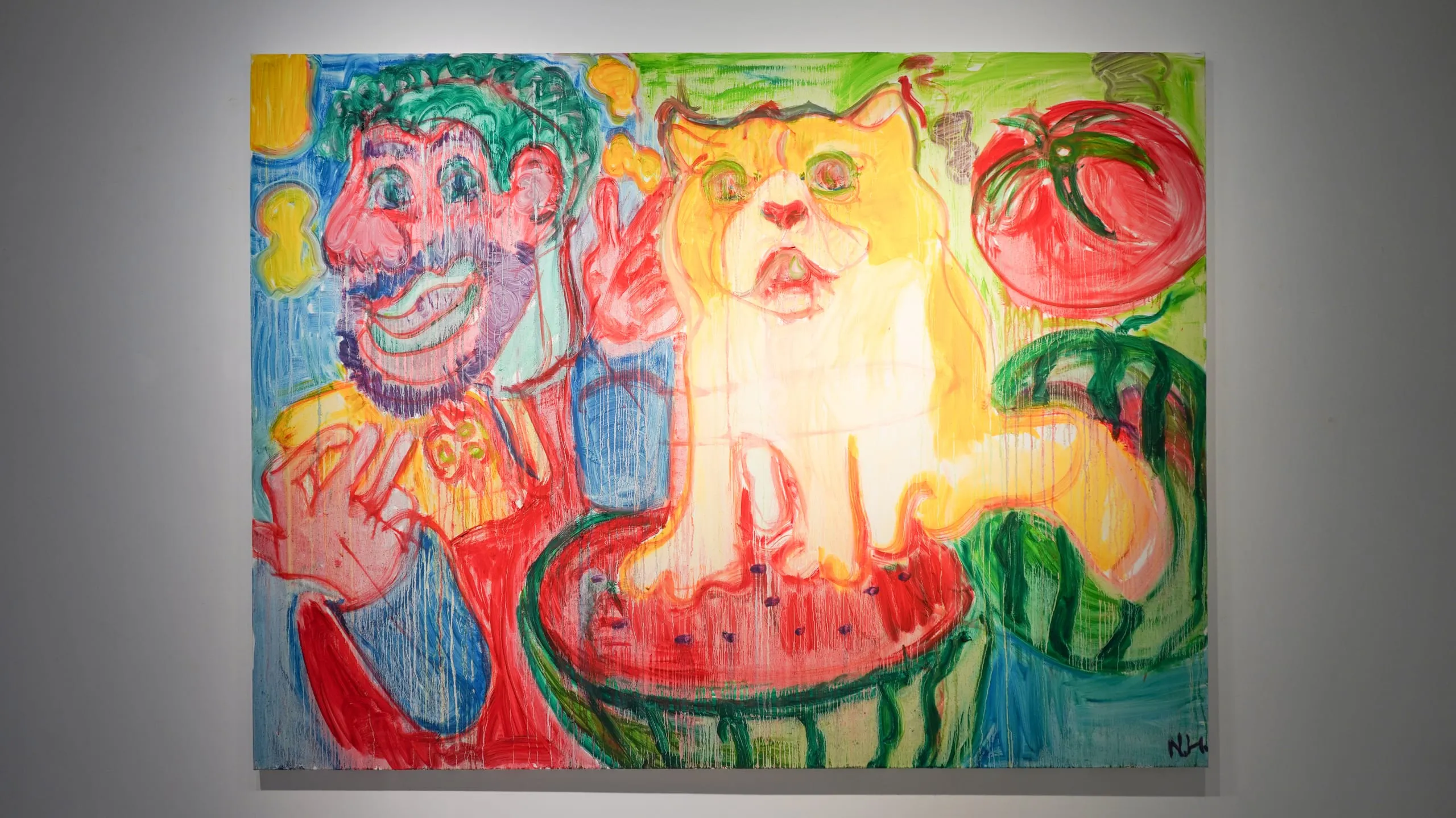 A grinning green-haired man and a ginger cat of equal size lean over a halved watermelon, a tomato floating beside them.